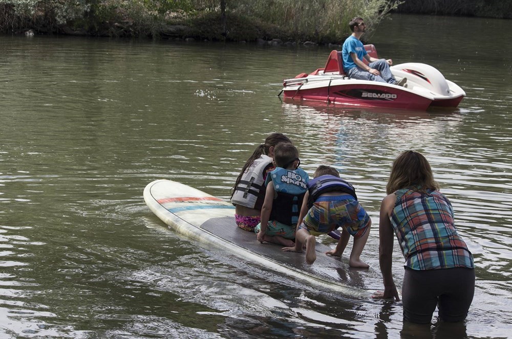 Kids paddle boarding.