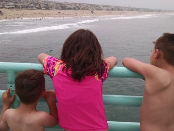 Photo of kids looking at the beach water