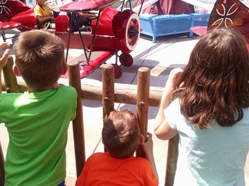 Photo of the kids waiting for their turn on the ride